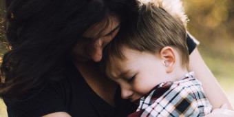 Mother comforting child.